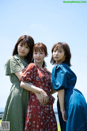 A couple of young women standing next to each other.