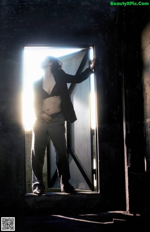 A woman laying on a chair in a dark room.