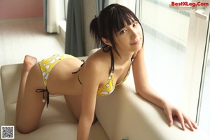 A young woman in a bikini posing for a picture.