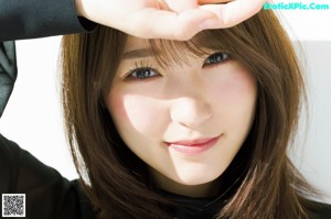 A woman in a black shirt is posing for a magazine.