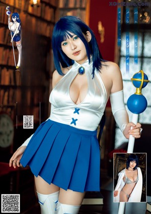 A woman in a blue dress with horns on her head.
