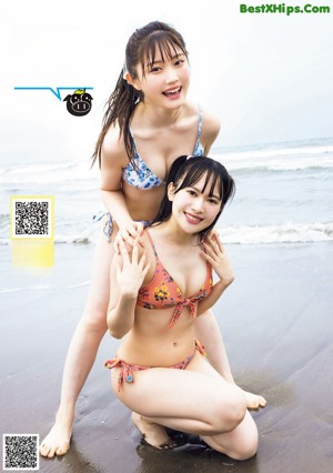 A group of young women in bikinis posing for a picture.