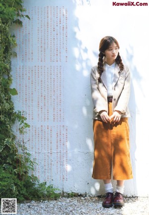 A woman with long brown hair and a white shirt.