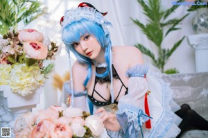 A woman dressed in a maid outfit posing for a picture.