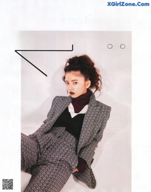 A magazine page with a picture of a girl eating a cake.