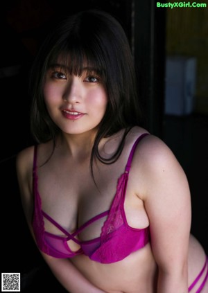 A woman in a blue bra and panties posing for a picture.