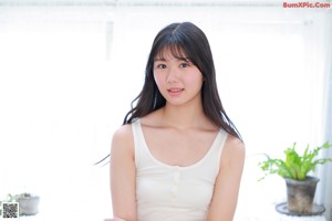 A young woman sitting on top of a chair.