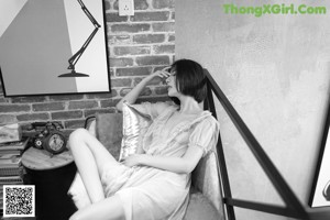 A naked woman sitting on a bed in a bedroom.