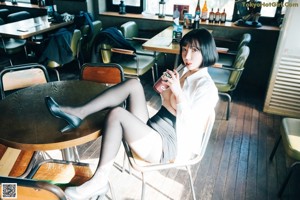 A woman sitting on top of a wooden table.