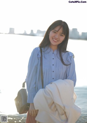 A woman in a white coat holding an ice cream cone.